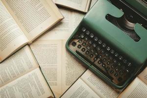 Top view of vintage typewriter with books and copy space photo