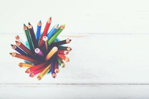 colored pencils on a wooden table photo