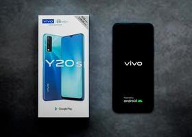 Vivo smartphone box and phone with Vivo logo on the screen. Vivo smartphone Y20s photo