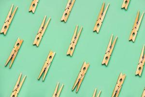 Top view of creative pattern made of wooden clothespins photo
