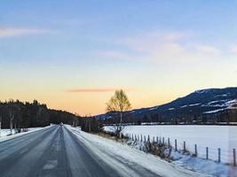 Snow-covered road through center of Hemsedal, Norway winter landscape.