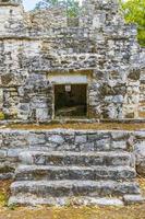 Ancient Mayan site with temple ruins pyramids artifacts Muyil Mexico. photo