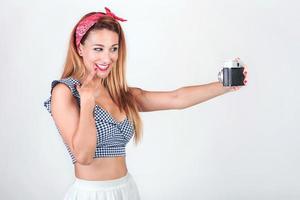 Portrait of pretty young woman using a camera photo