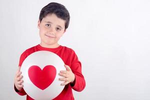 Smiling child with a heart photo