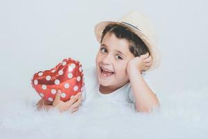 Smiling child with a heart-shaped balloon photo