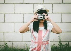 Portrait of young woman with camera photo