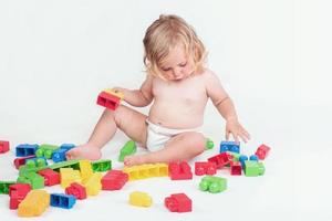 baby girl playing with building blocks photo