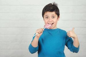 Funny kid with lollipop photo