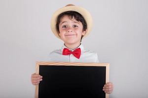 happy boy with a blackboard with hat and bow tie photo