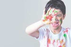 funny child with paint and a brush photo