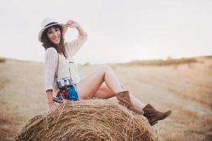 Smiling girl sitting on the straw photo