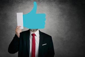 Businessman holding a like icon photo