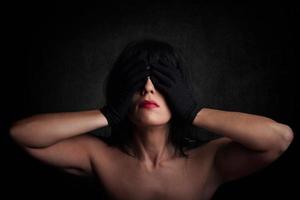 Sensual woman with hands on eyes photo