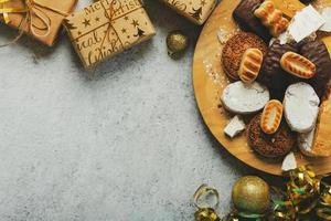 Top view of nougat christmas sweet,mantecados and polvorones with christmas ornaments and copy space. Assortment of christmas sweets typical in Spain. Selective focus photo