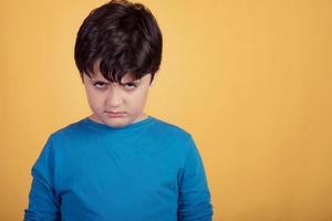angry boy on yellow background photo