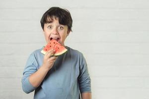 happy child eating watermelon photo