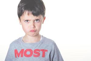 angry boy on a white wall photo