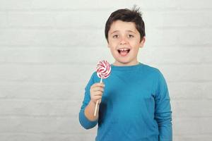 Funny kid with lollipop photo