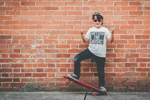 child with skateboard and sunglasses photo