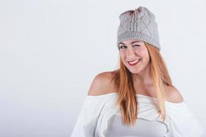 smiling and funny Young woman with winter hat photo