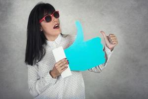 Young Woman holding a like icon photo