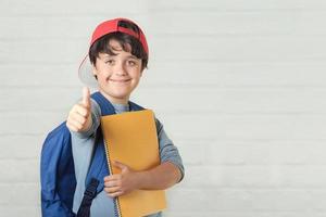 happy child with backpack and with notebook,back to school photo