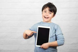 Happy child holding a tablet photo