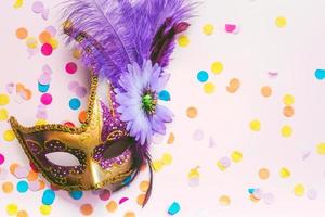 Venetian carnival mask and party confetti with copy space. Carnival celebration concept photo