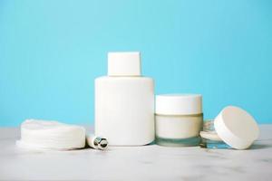 Skincare products.Cream jars,lotion, exfoliating cream and a cotton discs photo