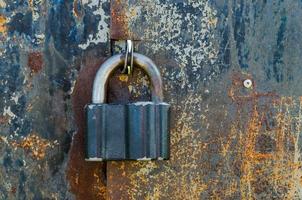 Old padlock on rusty gate photo