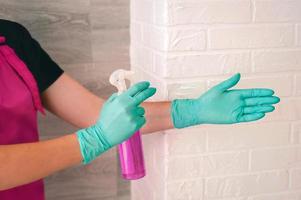 hands in latex gloves holding antiseptic bottle. Antiseptic bottle, safety, covid, cleanliness concept