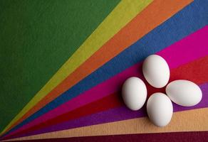 Easter eggs on top of colorful papers photo
