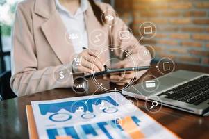 Businessman using mobile phone and laptop computer with business intelligence concept. with VR icon photo