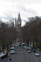 Aerial view of a wide street in London, with trees at both sides. Big ben in the distance photo