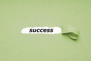 finding success concept - hole in paper background revealing hidden text photo
