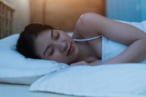 Beautiful young Asian woman is deep asleep and has a beautiful dream photo