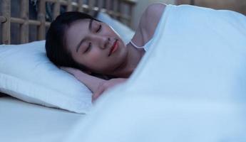 Beautiful young Asian woman is deep asleep and has a beautiful dream photo