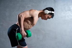 Muscular Asian man posing on gray background photo