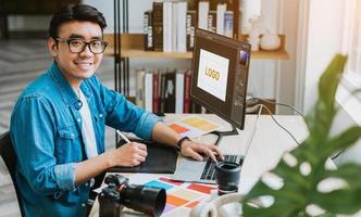 joven diseñador asiático que trabaja en la oficina foto