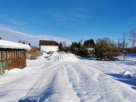winter day in the Russian village snow well blue sky photo