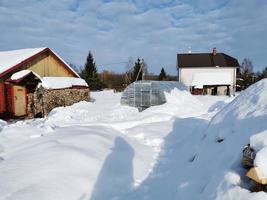 día de invierno en el pueblo ruso nieve bien cielo azul foto