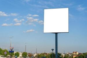 Outdoor advertising poster against the sky. photo