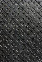 Black forged door, rhombus symmetrical texture. Grunge black background photo