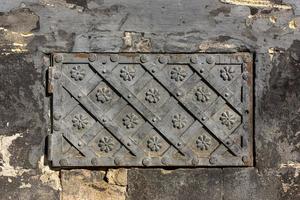 Black forged door, rhombus symmetrical texture. Grunge black background photo