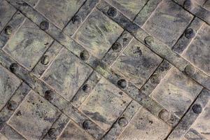 Black forged door, rhombus symmetrical texture. Grunge black background photo