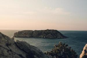 view of an island of the coast of the sea photo