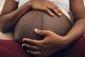 woman holding her belly  with his hands photo