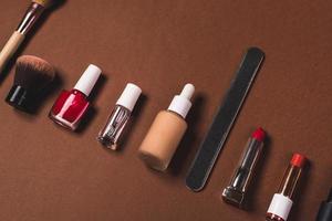 make up stuff on a brown red and cream color background