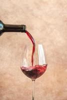 Red wine pouring into glass photo