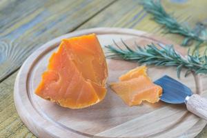 Mimolette cheese on the wooden board photo